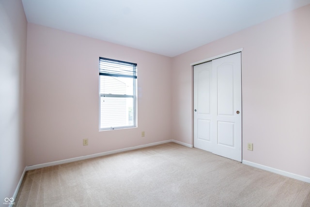 1404 Norton Dr, Greenwood, IN 46143 - unfurnished bedroom featuring light colored carpet, baseboards, and a closet