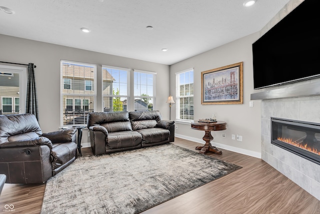 3546 Brampton Ln, Westfield, IN 46074 - living room featuring wood finished floors, a fireplace, recessed lighting, baseboards, and a textured ceiling
