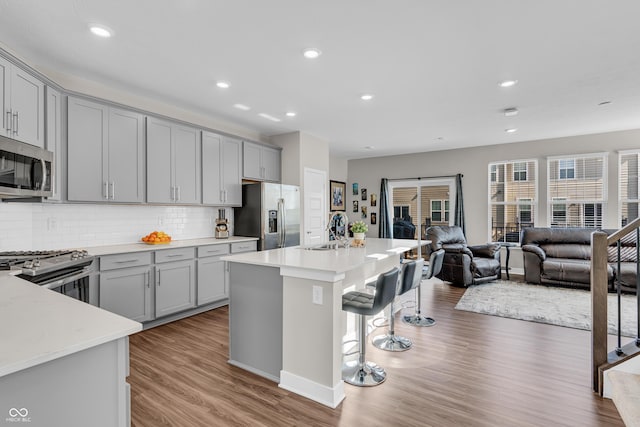 3546 Brampton Ln, Westfield, IN 46074 - kitchen with gray cabinetry, stainless steel appliances, a sink, open floor plan, and recessed lighting