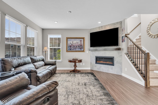 3546 Brampton Ln, Westfield, IN 46074 - living room with baseboards, wood finished floors, stairway, a tile fireplace, and recessed lighting