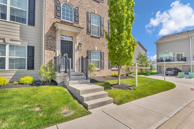 3546 Brampton Ln, Westfield, IN 46074 - view of exterior entry with brick siding and a lawn