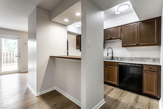 1142 Canterbury Sq S Unit B, Indianapolis, IN 46260 - kitchen with black dishwasher, a sink, light wood finished floors, baseboards, and recessed lighting