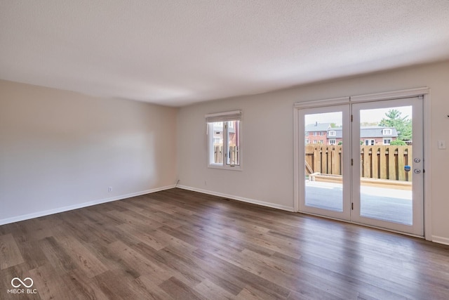 1142 Canterbury Sq S Unit B, Indianapolis, IN 46260 - empty room with dark wood finished floors, baseboards, and a textured ceiling