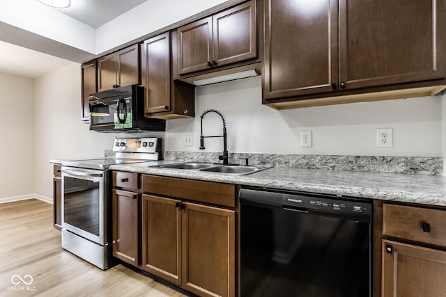 1142 Canterbury Sq S Unit B, Indianapolis, IN 46260 - kitchen with black appliances, a sink, light wood-style floors, and light countertops