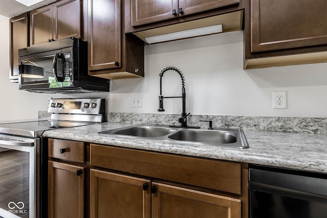 1142 Canterbury Sq S Unit B, Indianapolis, IN 46260 - kitchen with black appliances, a sink, light countertops, and dark brown cabinetry