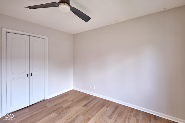 1142 Canterbury Sq S Unit B, Indianapolis, IN 46260 - unfurnished bedroom with light wood-type flooring, baseboards, a closet, and a ceiling fan
