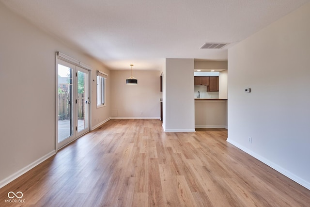 1142 Canterbury Sq S Unit B, Indianapolis, IN 46260 - unfurnished living room featuring light wood finished floors and baseboards