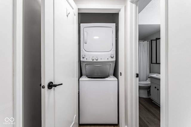1142 Canterbury Sq S Unit B, Indianapolis, IN 46260 - laundry area featuring stacked washer and clothes dryer and wood finished floors