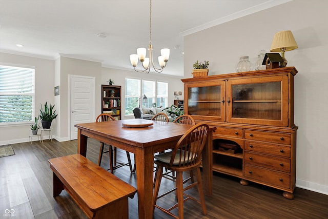 dining space featuring a chandelier, crown molding, baseboards, dark wood finished floors, and healthy amount of natural light