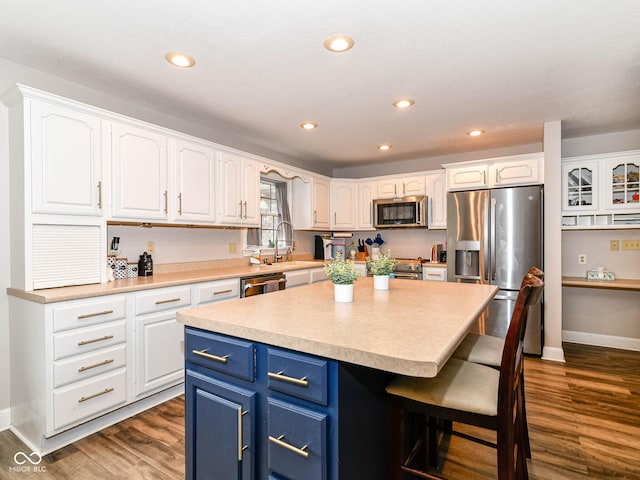 941 W Barouche, Pendleton, IN 46064 - kitchen featuring stainless steel appliances, blue cabinets, a sink, white cabinets, and recessed lighting