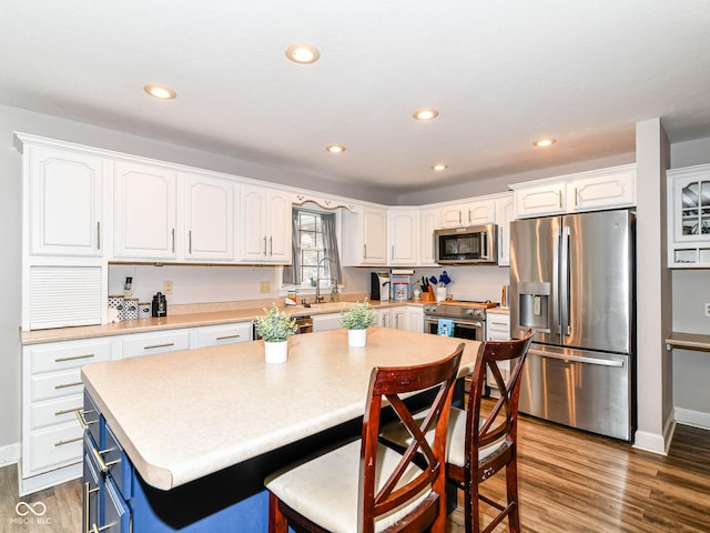 941 W Barouche, Pendleton, IN 46064 - kitchen featuring stainless steel appliances, white cabinets, blue cabinetry, and recessed lighting
