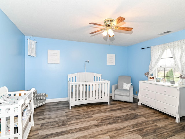 941 W Barouche, Pendleton, IN 46064 - bedroom featuring wood finished floors, a nursery area, baseboards, and ceiling fan