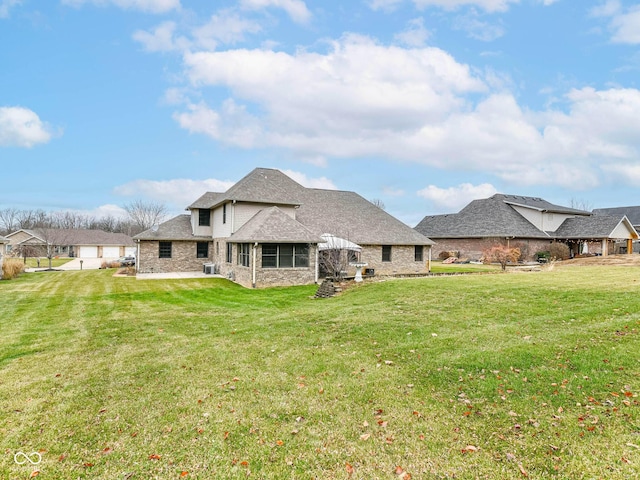 941 W Barouche, Pendleton, IN 46064 - rear view of property with a yard, a shingled roof, and brick siding