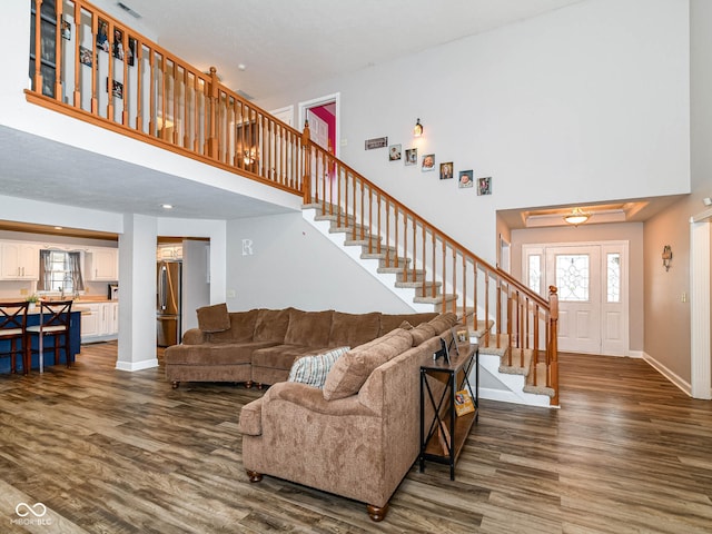 941 W Barouche, Pendleton, IN 46064 - living room featuring dark wood finished floors, stairs, a towering ceiling, and healthy amount of natural light