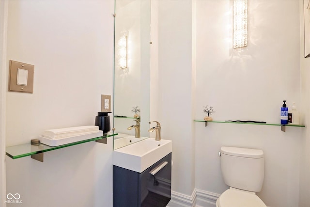 half bathroom with toilet and vanity