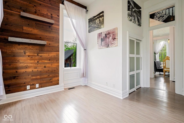 empty room with wood finished floors and baseboards