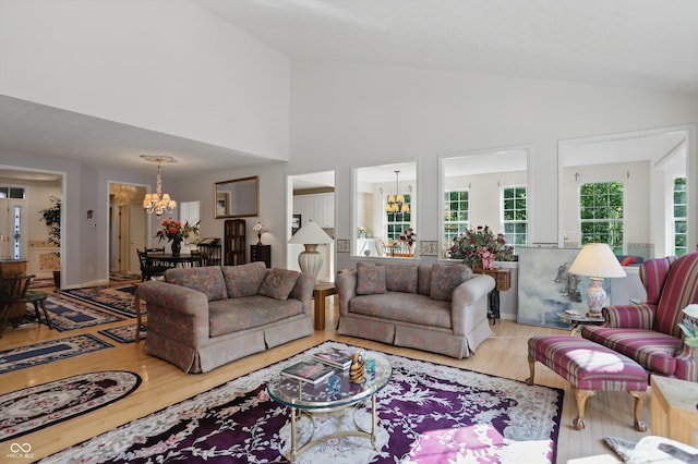 12065 Gray Eagle Dr, Fishers, IN 46037 - living room featuring a chandelier, wood finished floors, and high vaulted ceiling