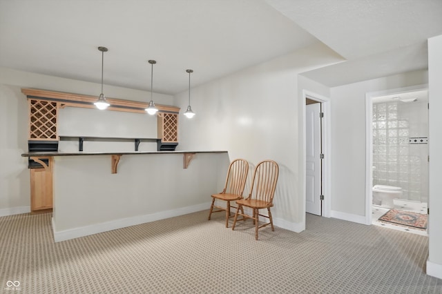 12065 Gray Eagle Dr, Fishers, IN 46037 - interior space with a kitchen breakfast bar, light colored carpet, and baseboards
