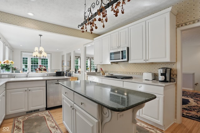 12065 Gray Eagle Dr, Fishers, IN 46037 - kitchen with stainless steel appliances, a sink, light wood-style floors, healthy amount of natural light, and recessed lighting