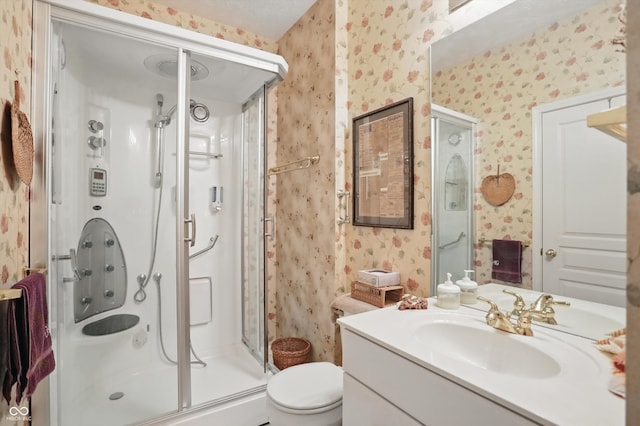 12065 Gray Eagle Dr, Fishers, IN 46037 - bathroom featuring wallpapered walls, a shower stall, vanity, and toilet