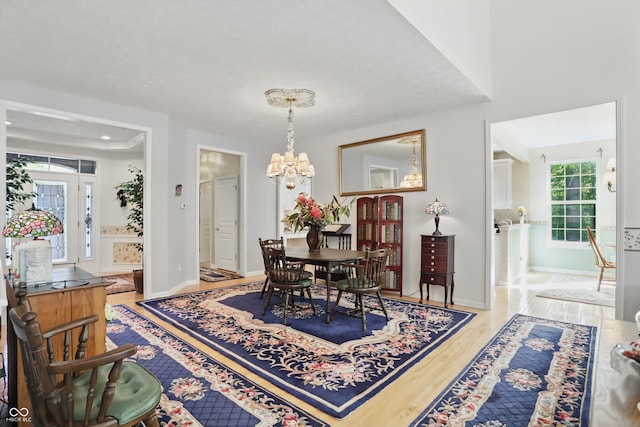 12065 Gray Eagle Dr, Fishers, IN 46037 - dining space featuring wood finished floors, a chandelier, and baseboards