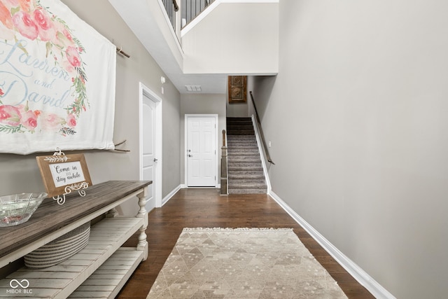 863 N Park Trail Dr, Carmel, IN 46032 - foyer featuring wood finished floors, stairway, baseboards, and a high ceiling