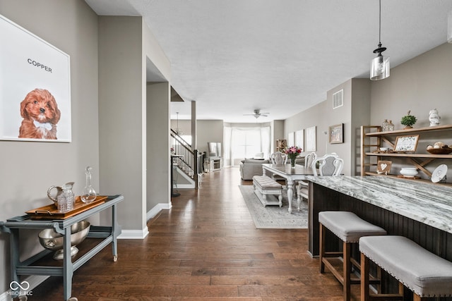 863 N Park Trail Dr, Carmel, IN 46032 - dining room with dark wood finished floors, stairs, a ceiling fan, and baseboards