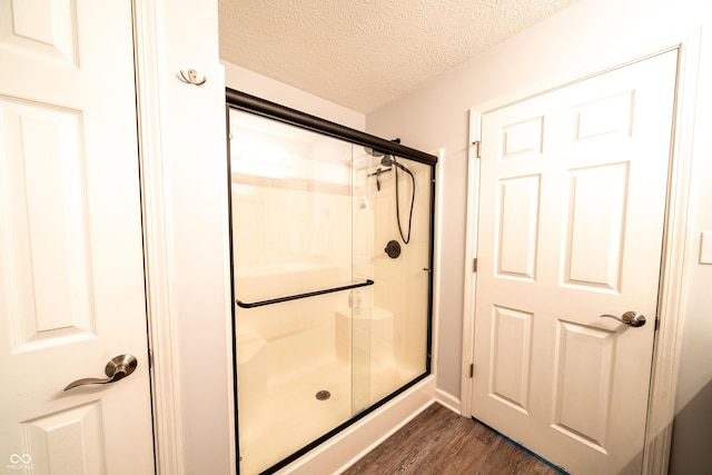 1334 Legacy Ct, Indianapolis, IN 46234 - bathroom featuring wood finished floors, a stall shower, and a textured ceiling