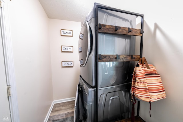 1334 Legacy Ct, Indianapolis, IN 46234 - laundry room featuring stacked washing machine and dryer, wood finished floors, and baseboards