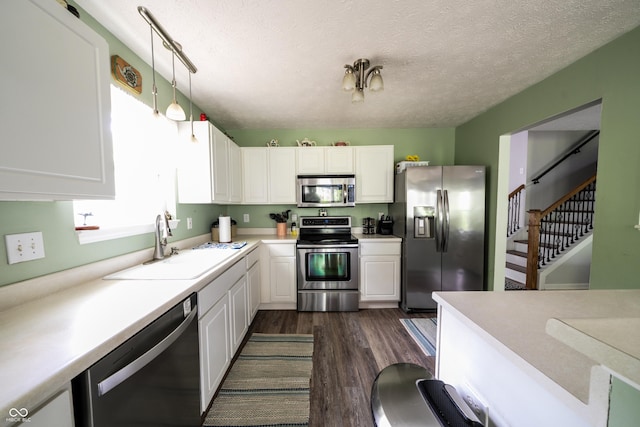 1334 Legacy Ct, Indianapolis, IN 46234 - kitchen featuring stainless steel appliances, a sink, dark wood-type flooring, white cabinets, and a textured ceiling