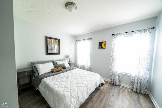 1334 Legacy Ct, Indianapolis, IN 46234 - bedroom with wood finished floors, baseboards, and a textured ceiling