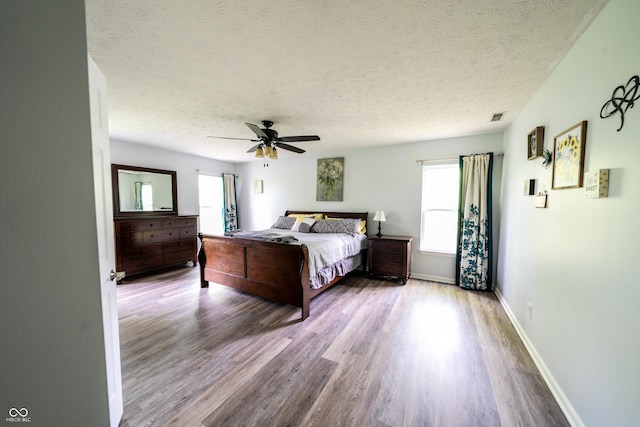 1334 Legacy Ct, Indianapolis, IN 46234 - bedroom featuring a textured ceiling, wood finished floors, baseboards, and a ceiling fan
