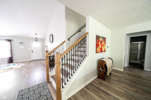 1334 Legacy Ct, Indianapolis, IN 46234 - staircase featuring vaulted ceiling, wood finished floors, a textured ceiling, and baseboards