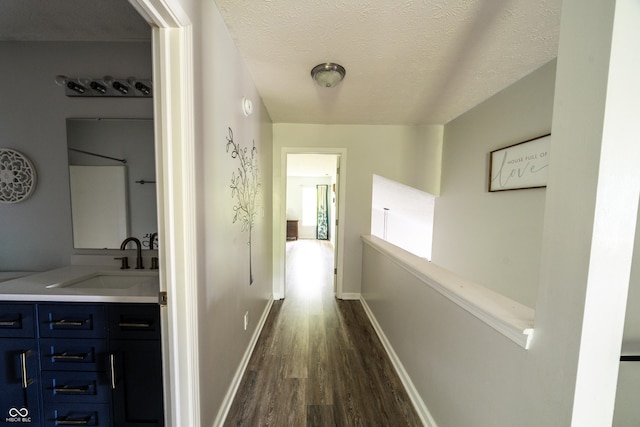 1334 Legacy Ct, Indianapolis, IN 46234 - hall with a sink, dark wood-type flooring, a textured ceiling, and baseboards