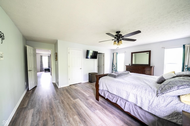1334 Legacy Ct, Indianapolis, IN 46234 - bedroom with wood finished floors, baseboards, ceiling fan, and a closet
