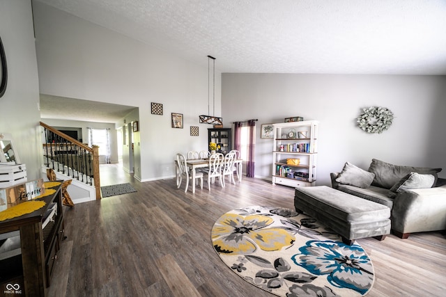 1334 Legacy Ct, Indianapolis, IN 46234 - living room featuring wood finished floors, stairway, high vaulted ceiling, a textured ceiling, and baseboards