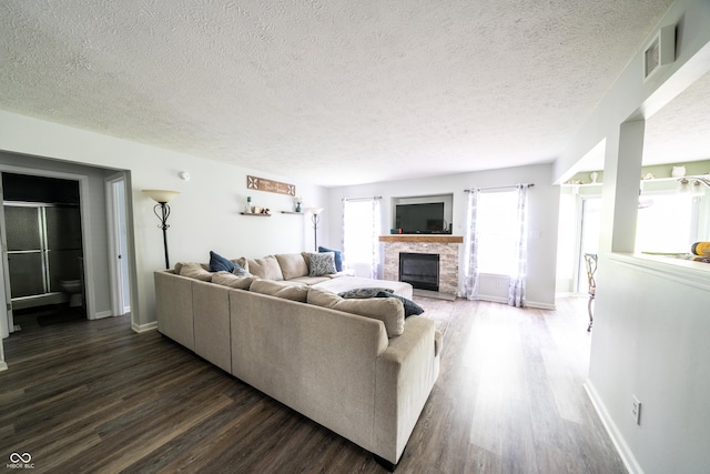 1334 Legacy Ct, Indianapolis, IN 46234 - living area with dark wood-type flooring, a glass covered fireplace, a textured ceiling, and baseboards