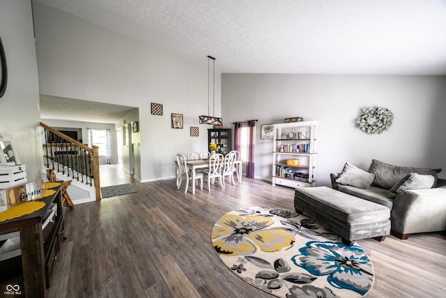 1334 Legacy Ct, Indianapolis, IN 46234 - living area featuring wood finished floors, stairway, high vaulted ceiling, a textured ceiling, and baseboards
