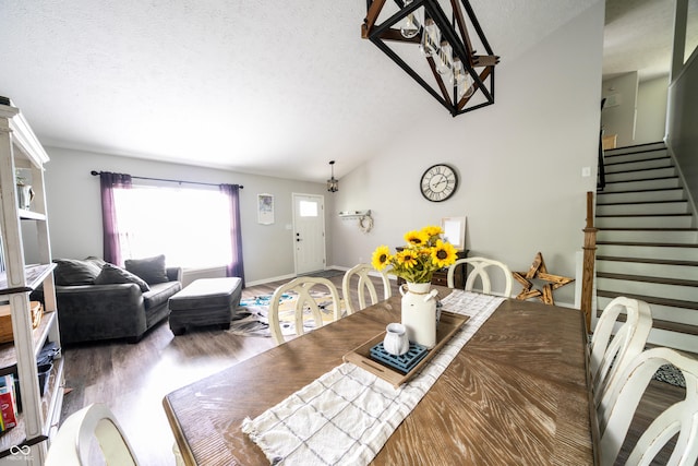 1334 Legacy Ct, Indianapolis, IN 46234 - dining space with wood finished floors, a textured ceiling, vaulted ceiling, stairway, and baseboards