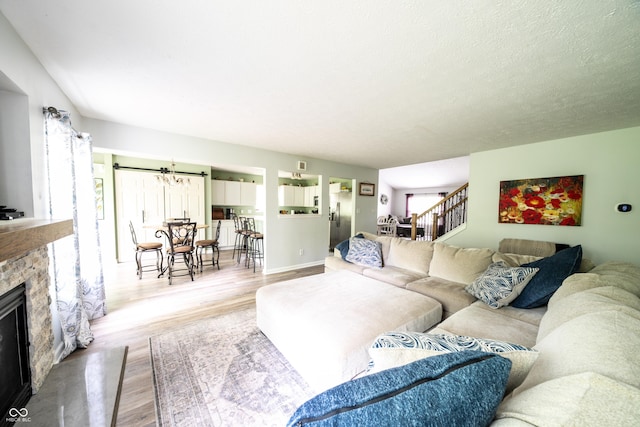 1334 Legacy Ct, Indianapolis, IN 46234 - living room with wood finished floors, a stone fireplace, stairs, and baseboards