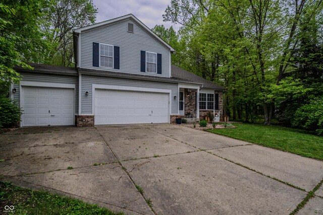 1334 Legacy Ct, Indianapolis, IN 46234 - view of front of house with driveway, a front yard, a garage, and brick siding