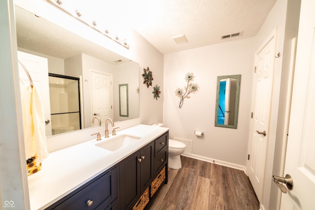 1334 Legacy Ct, Indianapolis, IN 46234 - bathroom with wood finished floors, baseboards, vanity, a shower with door, and toilet