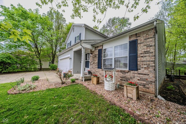1334 Legacy Ct, Indianapolis, IN 46234 - view of front of house featuring driveway, a garage, a front yard, and brick siding