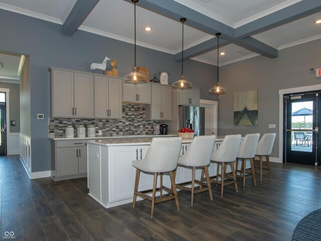 kitchen featuring stainless steel fridge with ice dispenser, beamed ceiling, decorative backsplash, light countertops, and ornamental molding