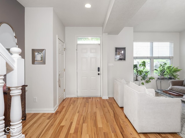 entrance foyer with light wood-style flooring, baseboards, and recessed lighting