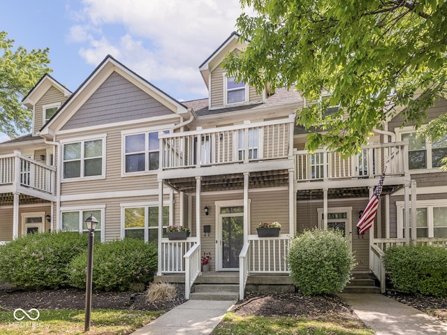 multi unit property with a balcony and covered porch