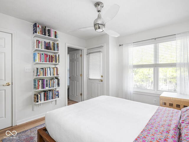 bedroom with light wood-style floors and a ceiling fan