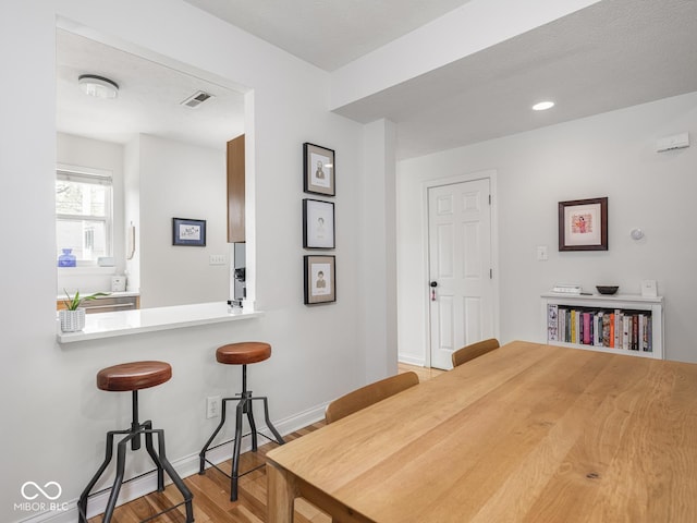 dining area with light wood-style floors and baseboards