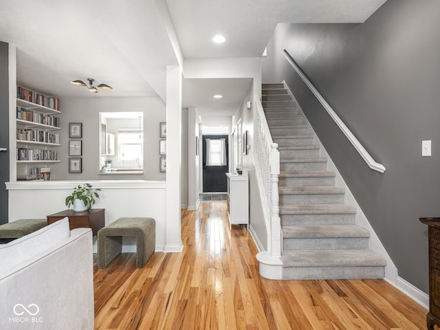 entryway with stairway, light wood-type flooring, baseboards, and recessed lighting