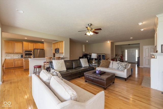 14018 Powder Dr, Carmel, IN 46033 - living room featuring a ceiling fan, light wood finished floors, recessed lighting, and a textured ceiling